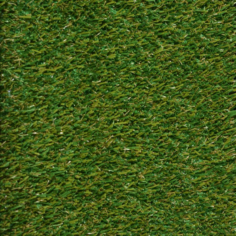 Close up shot of pet turf with green and brown grass strands Close up shot of pet turf with green and brown grass strands