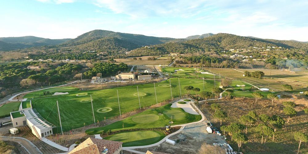 Tucson Aerial view of a synthetic grass golf course surrounded by hills