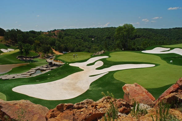 Tucson lush green synthetic grass golf course with white sand bunkers and blue sky